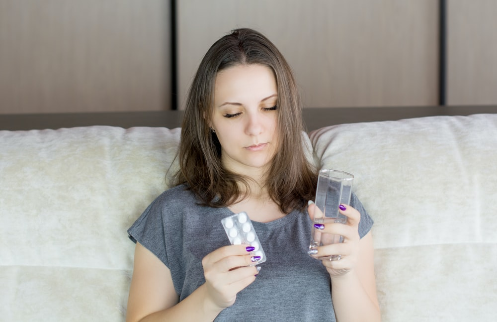 a woman holding her medicine 