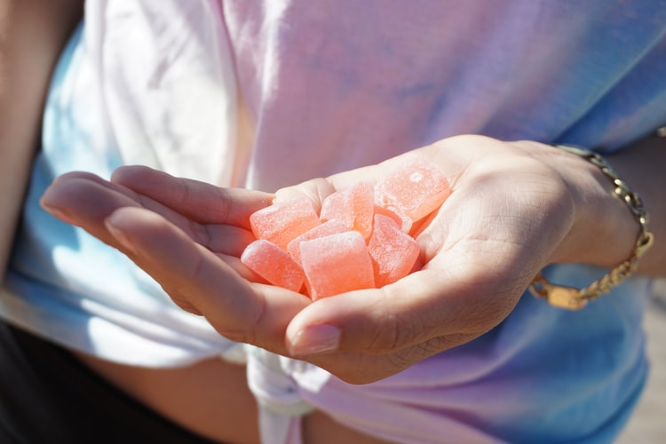 Person holding ACV gummies.