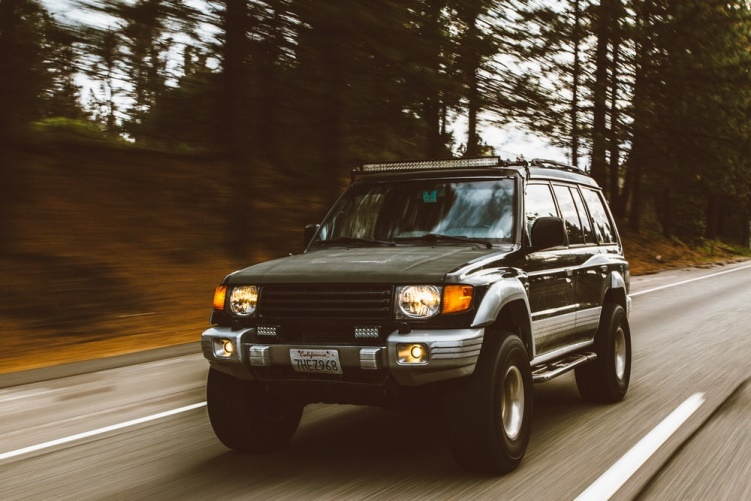 time-lapse photography of SUV on a road