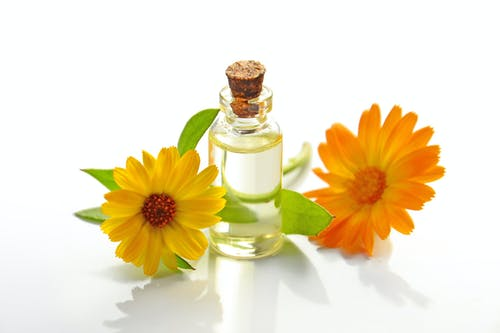 flowers around a bottle of castor oil 