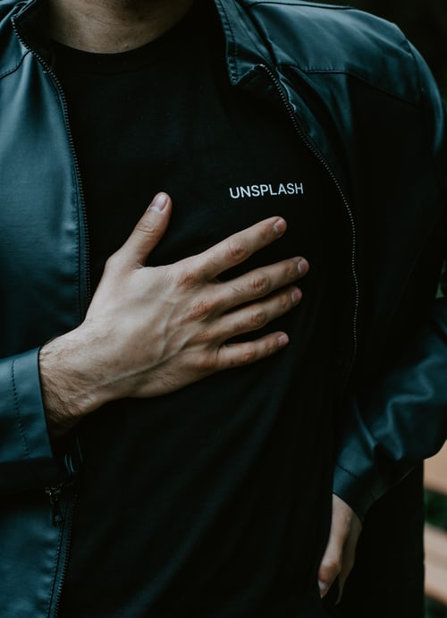 a man holding his chest due to pain