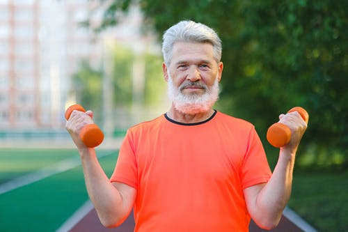 aged man lifting dumbbells