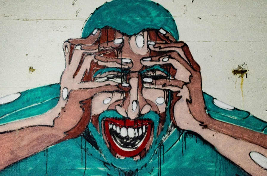Graffiti depicting a man with a headache