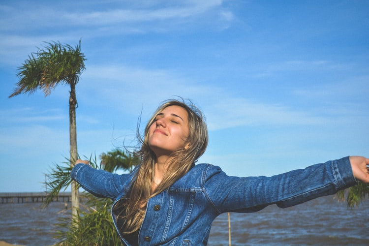 Healthy woman with arms spread wide. 