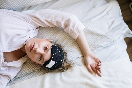 Woman lying in bed and unable to sleep
