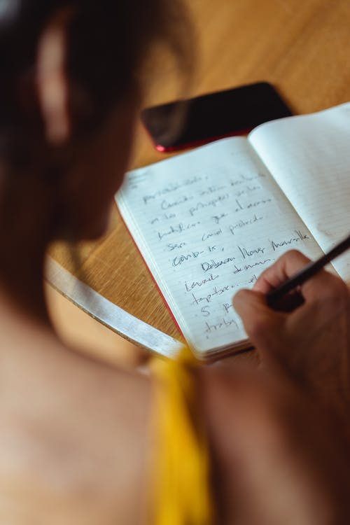 a woman making notes in her diary