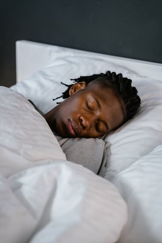  a man sleeping peacefully with the help of sleeping aids  for adults