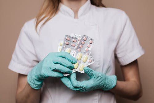 A nurse holding premium pharmaceutical supplements