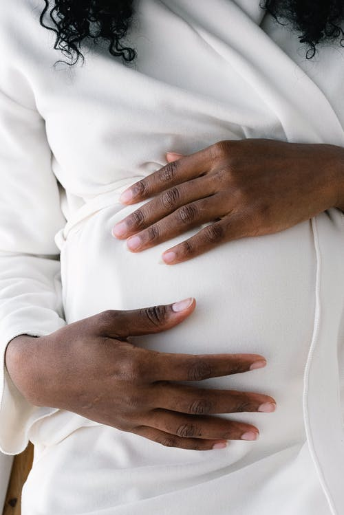 a pregnant lady touching her belly