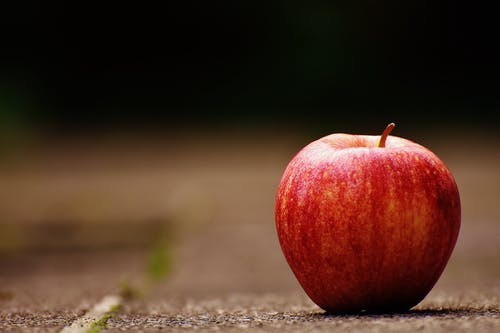 A red apple lying on the ground