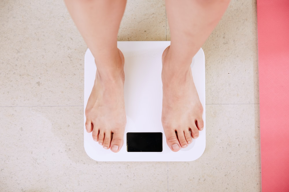 a person weighing their weight