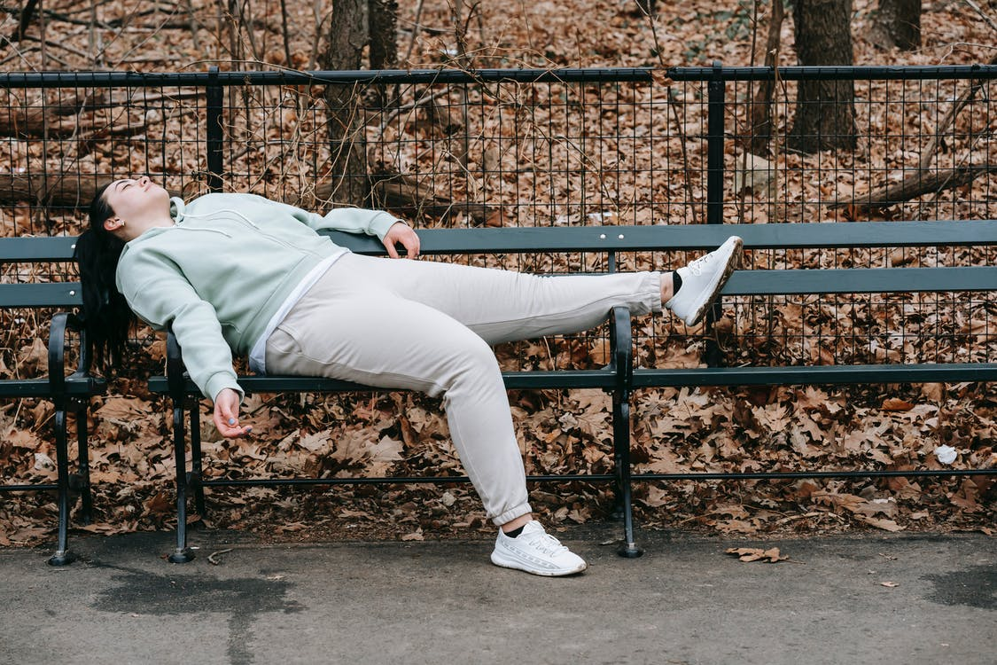 a tired woman resting on a bench