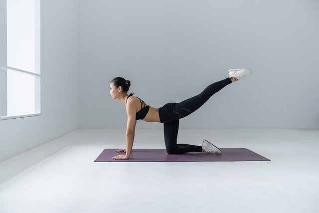 A woman stretching on a yoga mat