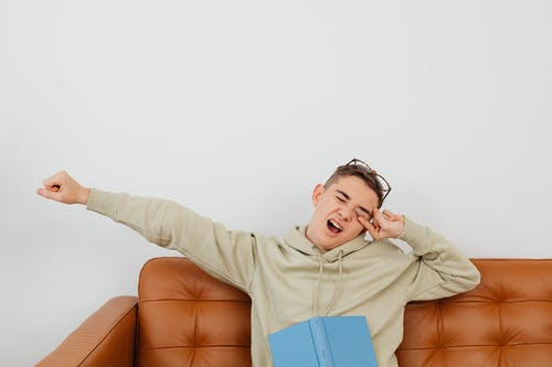 a person stretching their arm and yawning